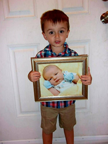 Tiffany Lafon Martin's Tubal Reversal baby boy is 3 years old now and holding a picture of himself as a newborn