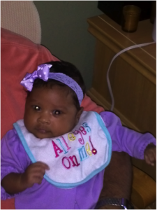 beautiful and healthy tubal reversal baby girl dressed in purple