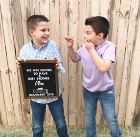 big brothers kidding around while mom tries to take picture of them announcing they will have a tubal reversal baby brother or sister in november 2018