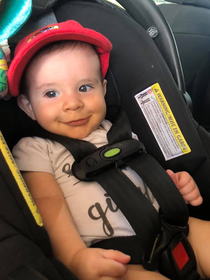 nancy marie's tubal reversal baby sitting in his car seat with a red cap on