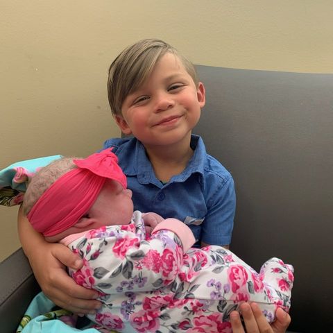 big brother and first tubal reversal baby, croix, holding second tubal reversal baby girl, dallas