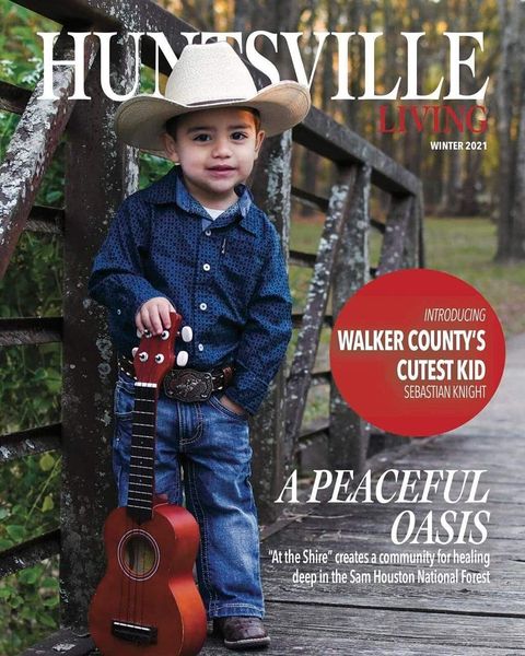 nora' knights tubal reversal baby dressed in cowboy gear with a toy guitar on on the cover of Huntsville, a Walker County Texas magazine