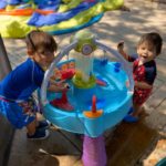 2 boys playing at a water table that were born after their mother had an essure reversal