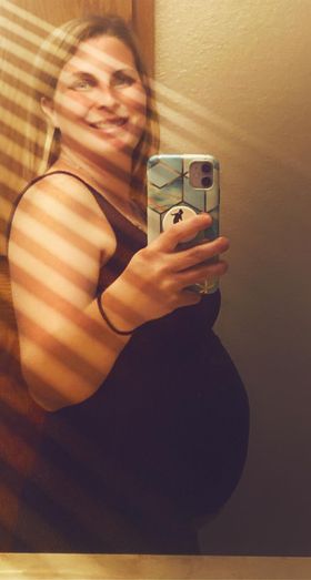 selfie of crystal cain pregnant with her first tubal reversal baby