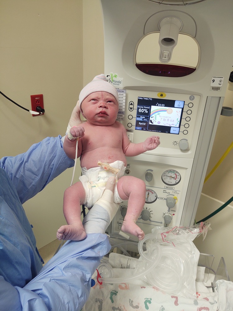 perla hodgins' tubal reversal newborn baby girl held by a nurse just after birth
