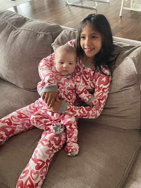 rachel lynn maloney's tubal reversal babies born 9 years apart pose for a picture in matching pajamas